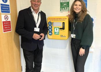 two people and a defibrillator