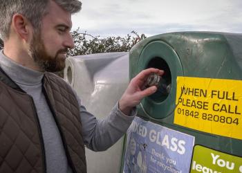 Man using glass bottle bank