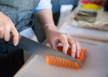 person slicing fish