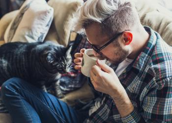 young man and cat