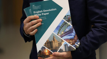 Image of a Government Minister holding the English Devolution White Paper
