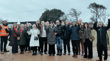 A group of people on a sports ground celebrating