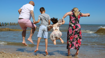 Family jumping by the sea