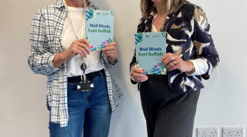 Cllrs holding a booklet that reads 'Well Minds'