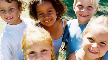 group of five young children smiling