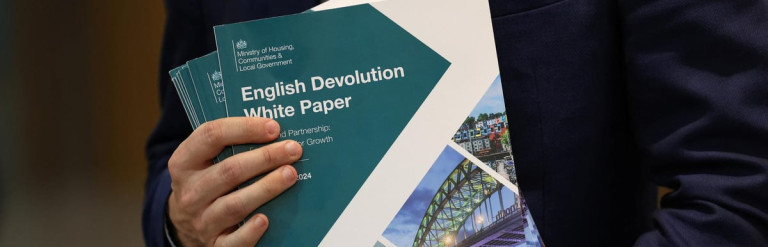 Image of a Government Minister holding the English Devolution White Paper