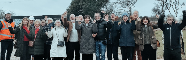 A group of people on a sports ground celebrating