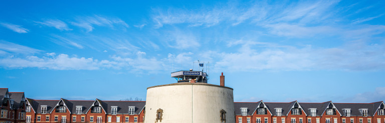 Blue skies with a round building