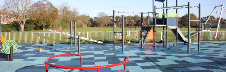 A play area with a roundabout and slide
