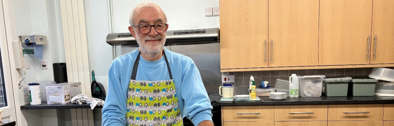 A man serving tea in a kitchen
