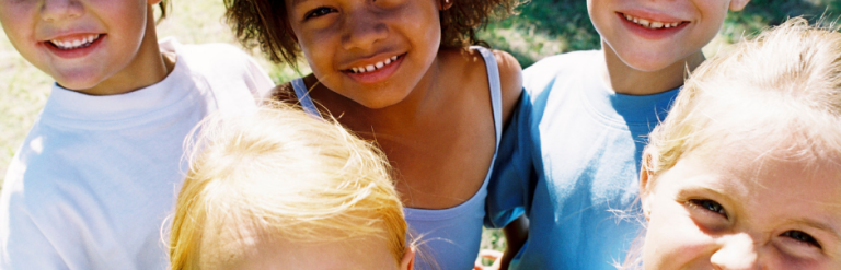 group of five young children smiling